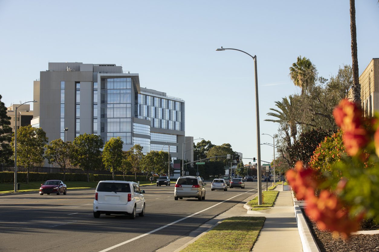 Daytime view of the downtown street, with cars, building, and skyline of Torrance, California, USA